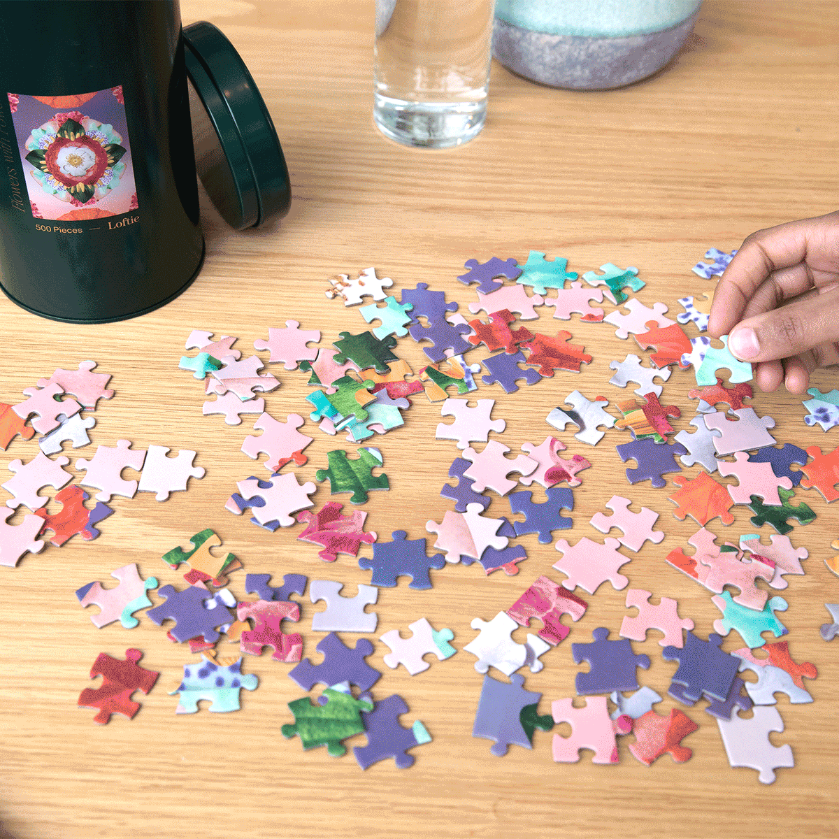 Animated clip of hands reaching for the Flowers with Powers puzzle