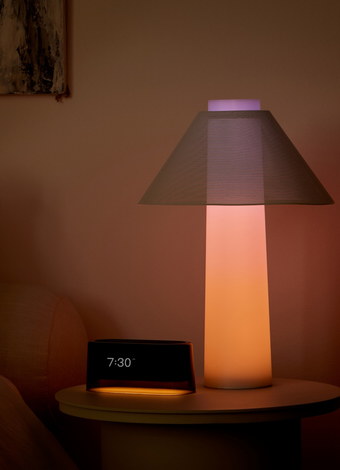 Loftie Lamp glowing warm on a nightstand beside the Loftie Clock