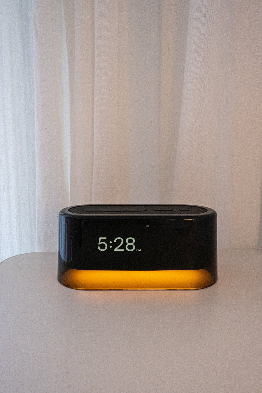 Loftie Clock showing 5:28 on a white nightstand