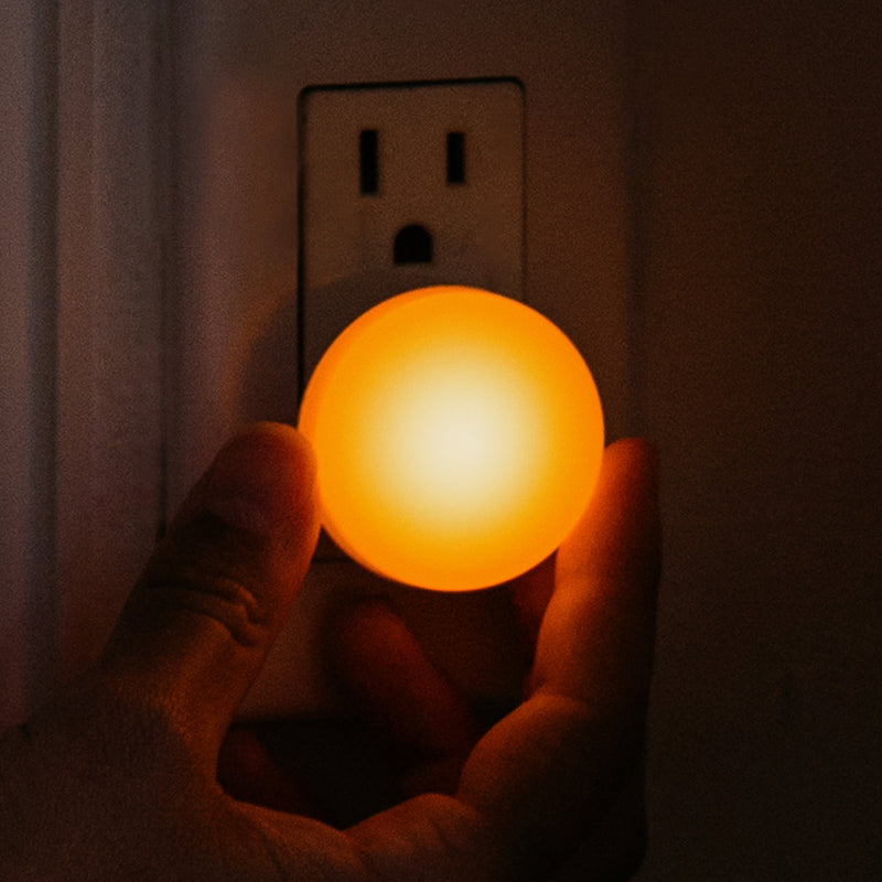 Close-up of a glowing Night Light at an outlet