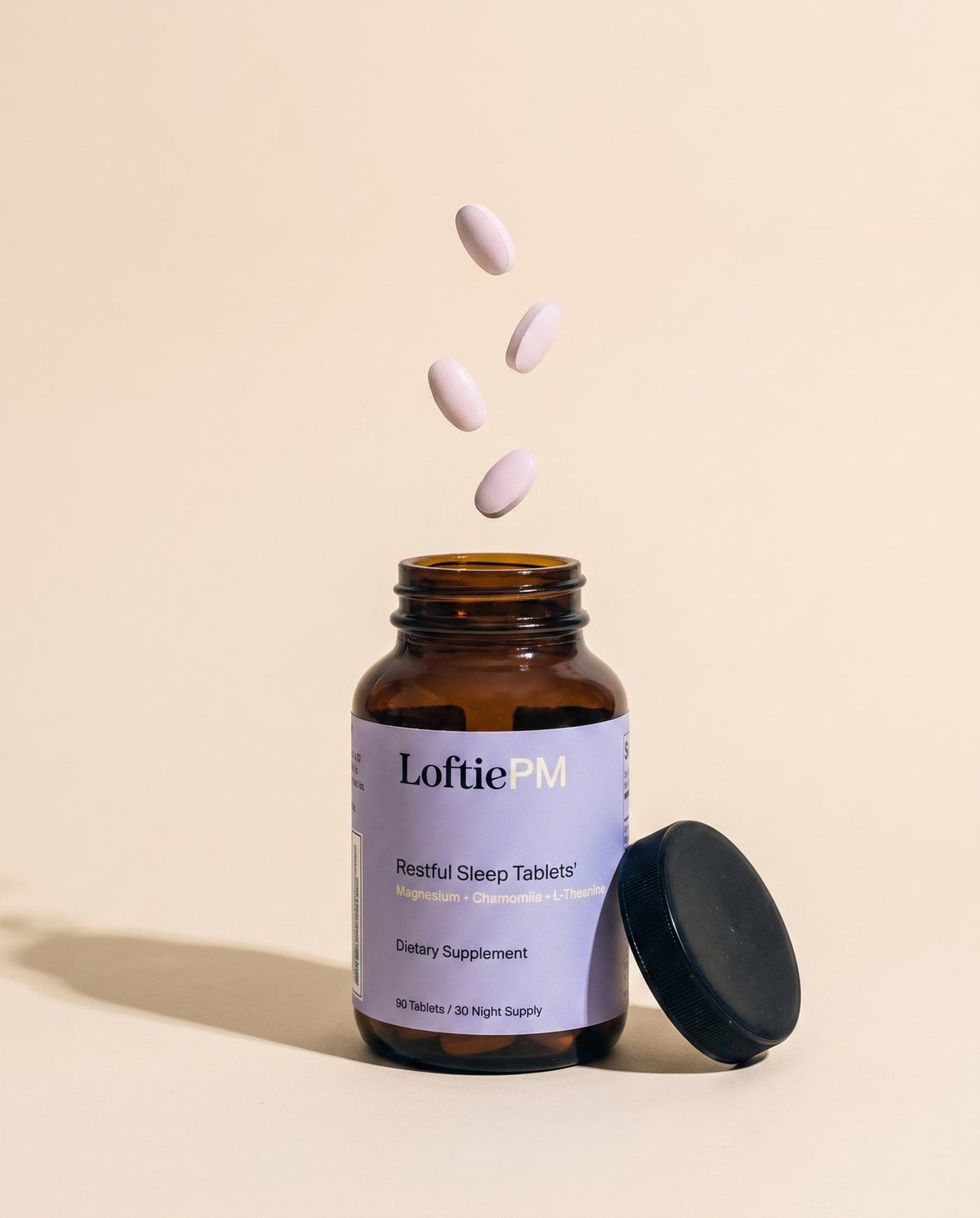 An open bottle of LoftiePM with tablets falling into it