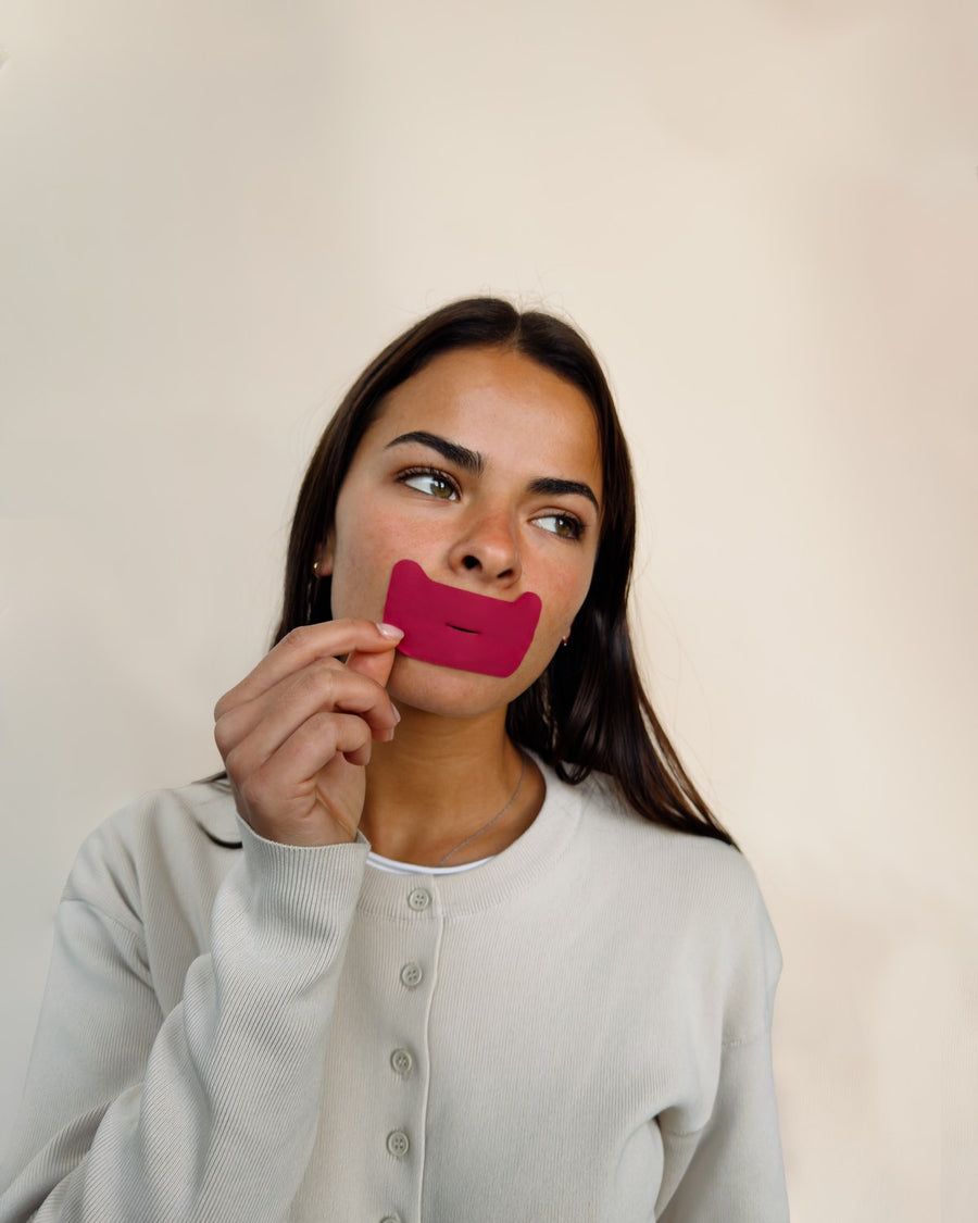 Pressing mouth tape over closed lips