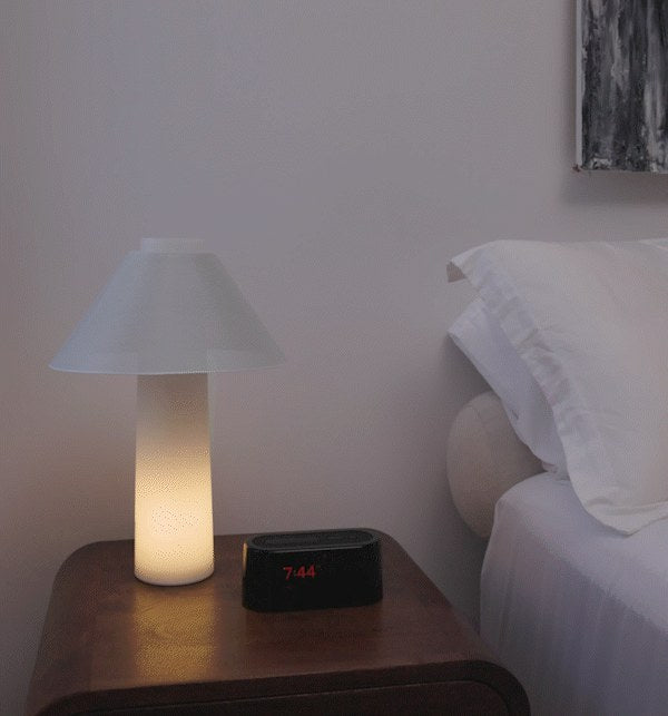 Loftie Lamp glowing beside a Loftie Clock on a nightstand